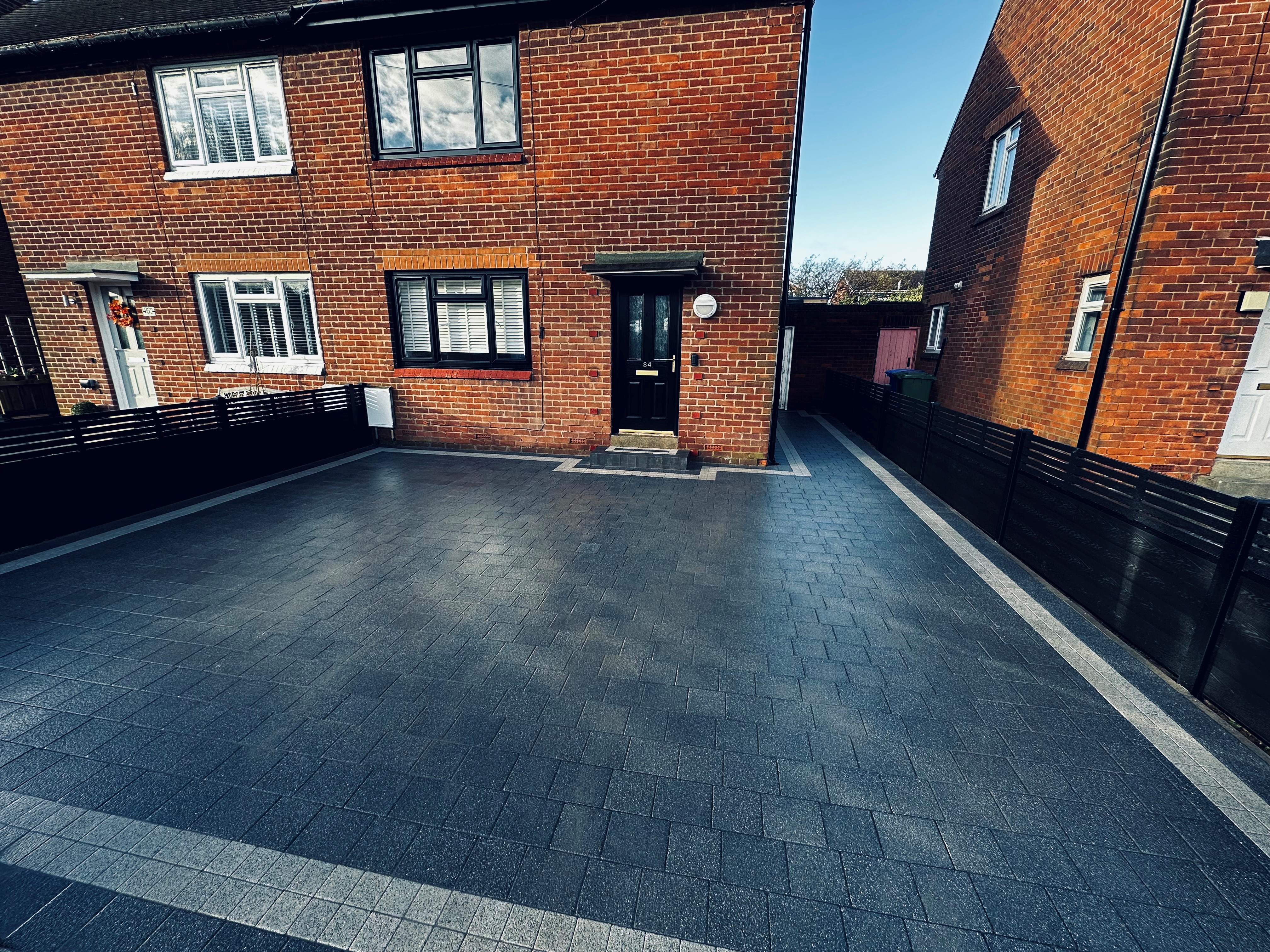 Charcoal block paved driveway to a semi detached house